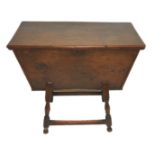 A 19th Century oak dough bin the rectangular hinged top above opening sides and on turned legs