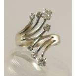 A seven diamond spray style cluster ring the combined approximate total is 0.60cts, claw set to