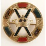 A yellow metal Scottish agate brooch with Celtic knot work engraved panels and a crown to the centre