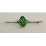 A 9ct white gold Art Deco brooch set with a Chinese green hardstone carved with foliate forms,