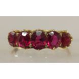 A five stone ruby ring the five graduated rubies are claw set to a scallop shaped mount, finger size