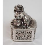 A Chinese silver octagonal incense burner cast as a shishi with brocade ball on a pierced cover with