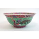 A Chinese bowl painted with an exotic bird, rockwork and chrysanthemum on a green ground, printed