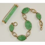 A 9ct gold Chinese green hardstone bracelet the five panels are carved with branches with fruit,