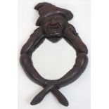 A 19th Century Tam O'Shanter carved wood mirror formed as the head, arms and legs of the renowned