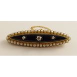 A Victorian mourning brooch in bright yellow metal with locket back, set with onyx, diamonds and