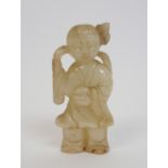 A Chinese hardstone carving of a young boy standing and holding a sceptre and a peach, 7cm high