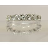 A white metal diamond set eternity ring set with an estimated total of approx 1cts spread across