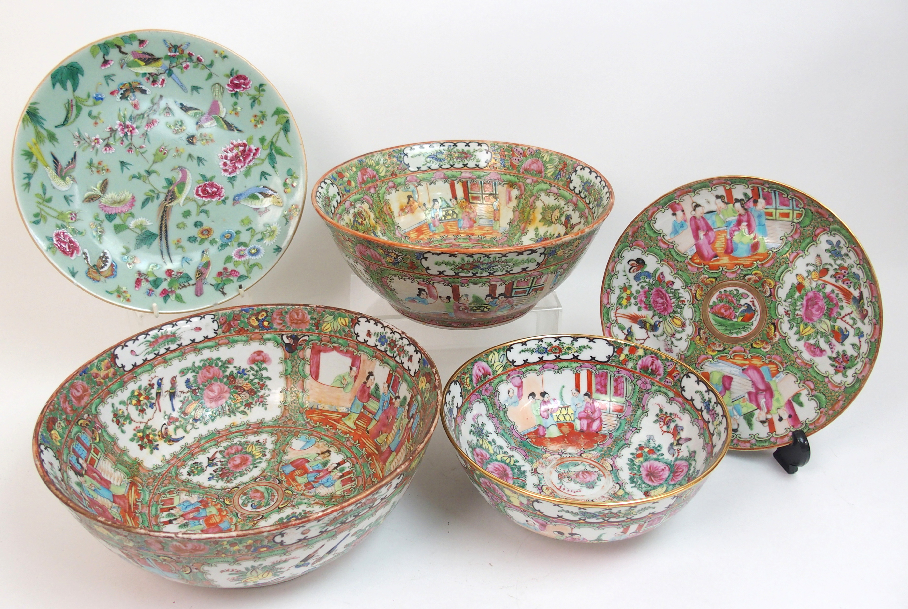 A Canton famille rose punch bowl of traditional design with panels of figures, birds, fruit and