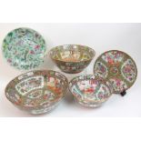 A Canton famille rose punch bowl of traditional design with panels of figures, birds, fruit and