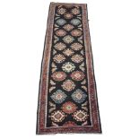 A black ground full pile Persian runner with unique design, 323 x 95cm