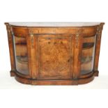 A Victorian walnut credenza with inlaid panelled door flanked by a pair of convex glass doors