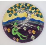 Elizabeth Mary Watt (1886-1954) A pottery charger hand painted with a seated green pixie playing a