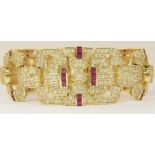 A 14ct ruby and diamond bracelet of Art Deco style the open work panels are set with both round