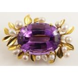 An 18ct gold Scottish river pearl and amethyst pendant brooch the mount is decorated with stylized