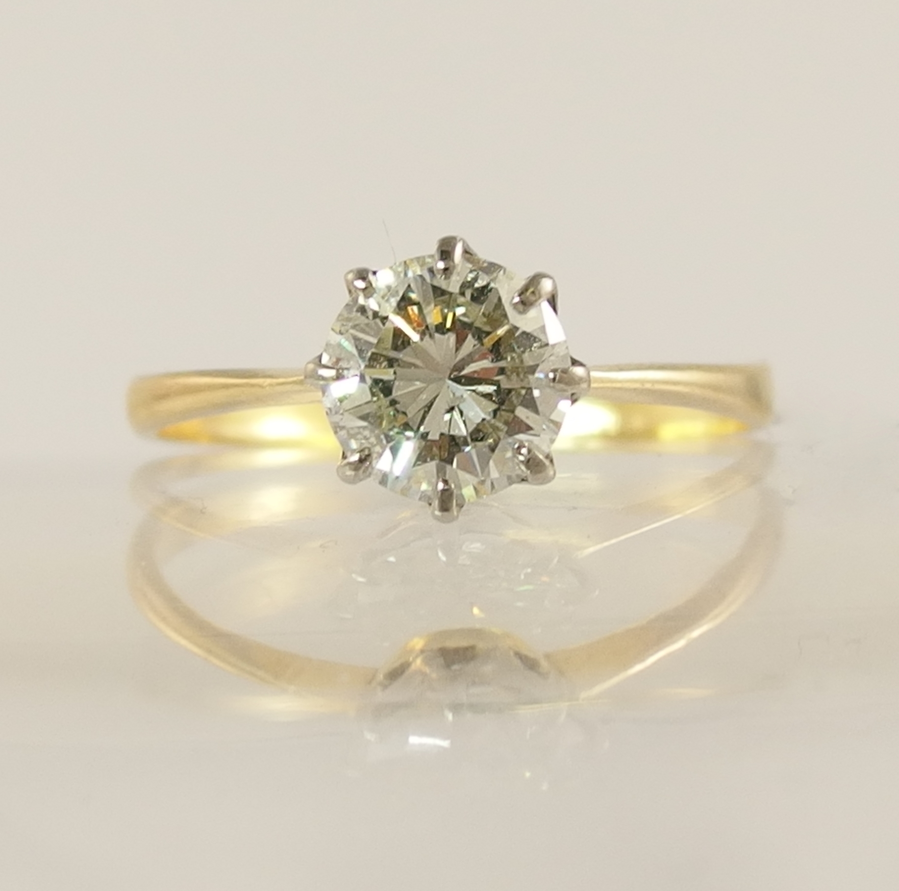 A 1.12ct diamond solitaire ring with classic crown mount in white metal with a tapered yellow - Image 2 of 6