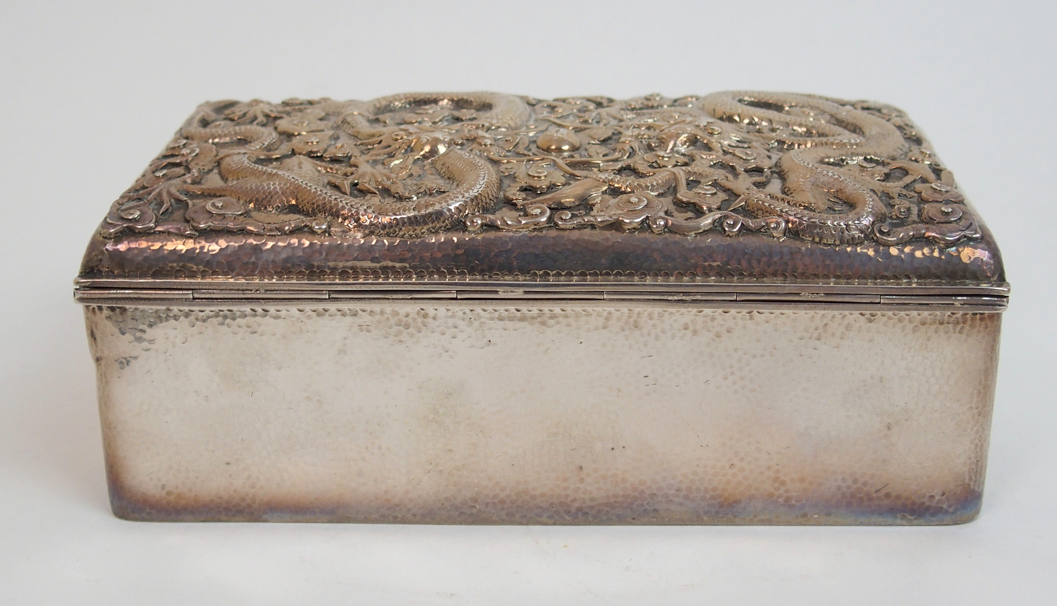 A Chinese silver hammered rectangular cigar box the hinged cover decorated with two facing dragons - Image 4 of 10