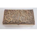 A Chinese silver hammered rectangular cigar box the hinged cover decorated with two facing dragons