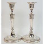 A pair of late Victorian silver candlesticks by Daniel and John Wellby, London 1896, of oval