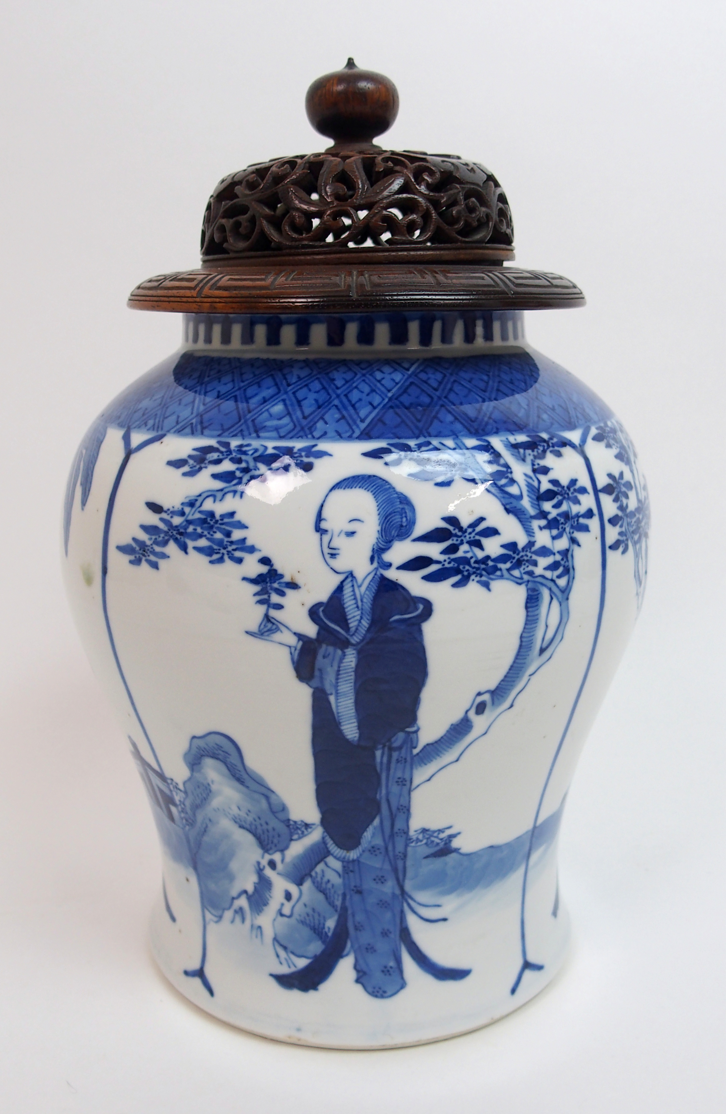 A Chinese blue and white baluster vase painted with long Elisa in a garden beneath trees and a