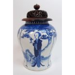 A Chinese blue and white baluster vase painted with long Elisa in a garden beneath trees and a