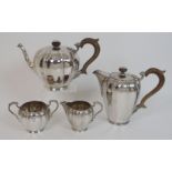 A four piece silver tea service by Revel Co., Birmingham 1913, of tapering cylindrical form, the