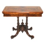 A Victorian walnut card table the hinged fold-over top on a fluted quadripartite scroll base