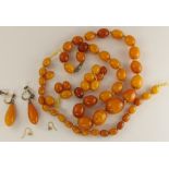 Two amber coloured bead necklaces and a pair of earrings largest bead approx 20.4mm x 16.5mm,