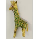 A yellow metal giraffe brooch set with diamonds and ruby the body enamelled in green, with