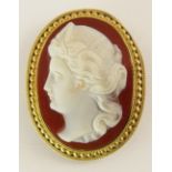 A carved hardstone cameo of a maiden in 15ct gold mount, with rope work and beaded edge, 35mm x