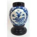 A Chinese blue and white jar painted with panels of precious objects in an ice cracked blossom