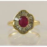 An 18ct yellow gold diamond and ruby cluster ring the central oval ruby of approx 6.1mm x 5.13mm x