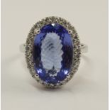 An 18ct white gold tanzanite and diamond ring the oval mixed cut tanzanite of approx 4.75cts, is