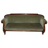 A Victorian mahogany upholstered scroll back settee on ring turned tapering legs on brass castors,