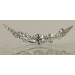 A diamond crescent moon brooch of approx 1.75cts the central diamond is 0.76cts and flanked by two