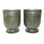 A pair of Kashmiri metal jardinieres decorated with meandering foliage within bands of