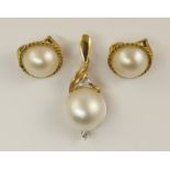 An 18ct white mabe pearl and diamond pendant with a pair of similar white mabe pearl clip