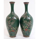 A pair of Japanese hexagonal baluster vases decorated with blossoming trees and various flora within