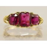 An 18ct gold three stone ruby ring in a Victorian style pierced galleried mount finger size N1/2