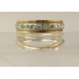 A full diamond set eternity ring in yellow and white metal with textured yellow metal edges, diamond