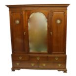 An Arts and Crafts walnut bedroom suite carved with foliate roundels enclosing abalone shell