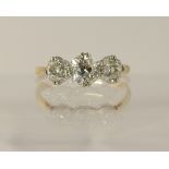 An 18ct three stone old cut diamond ring of approx 1.23cts in classic crown mounts with tapered