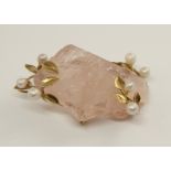 An unusual Scottish river pearl and rose quartz pendant brooch featuring a partly cut and polished