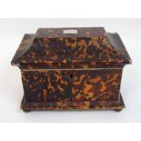 A Georgian tortoiseshell double tea caddy of sarcophagus form the lid with inlaid rectangular