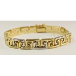 An 18ct gold Greek key design bracelet each alternate key is either in yellow or white gold, with