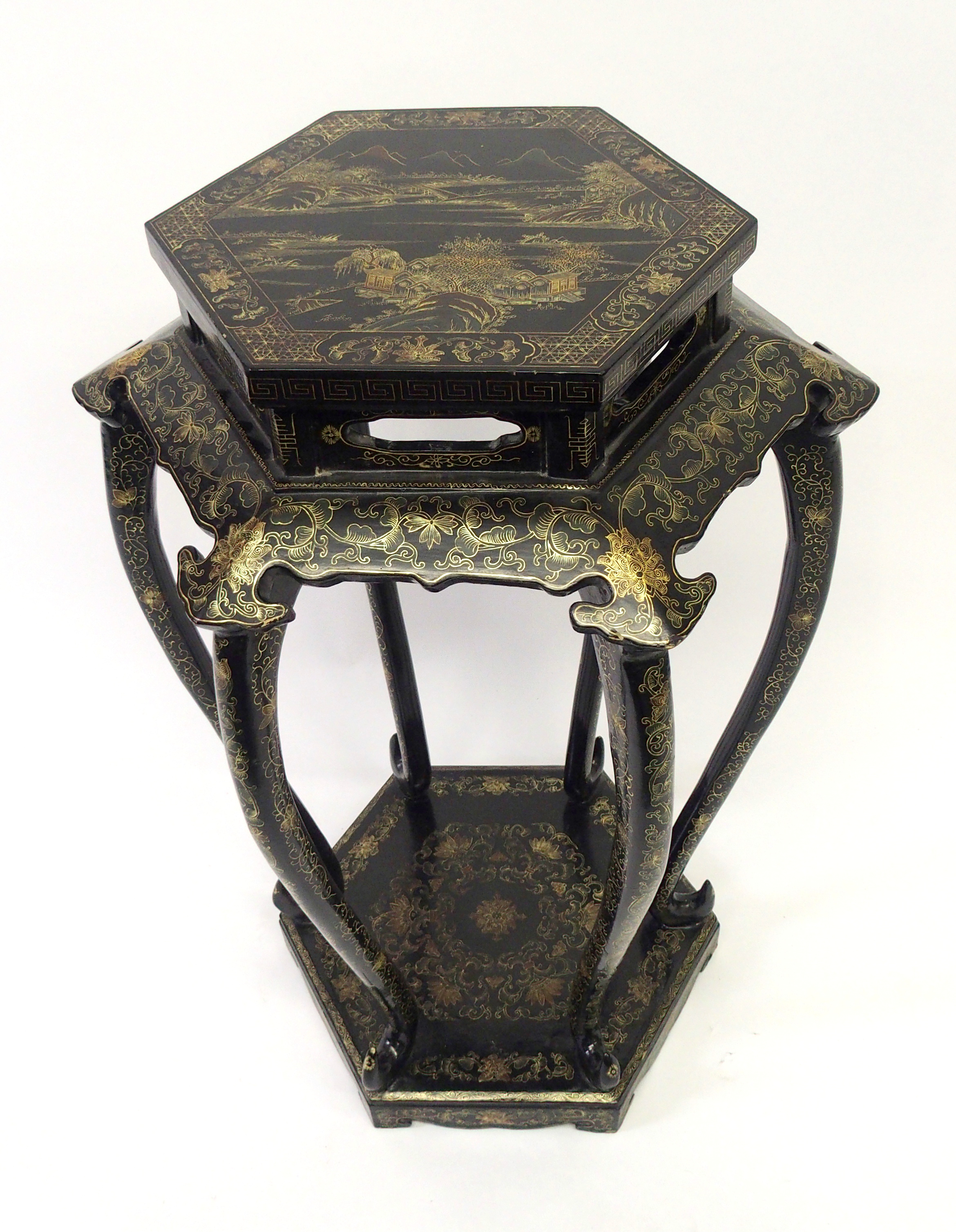 A Chinese black and gold hexagonal pedestal painted with a landscape above scrolling foliage on