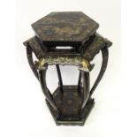 A Chinese black and gold hexagonal pedestal painted with a landscape above scrolling foliage on