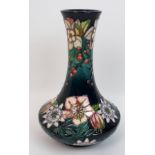A Moorcroft Passion flower pattern vase of tapering squat form with tube lined decoration,