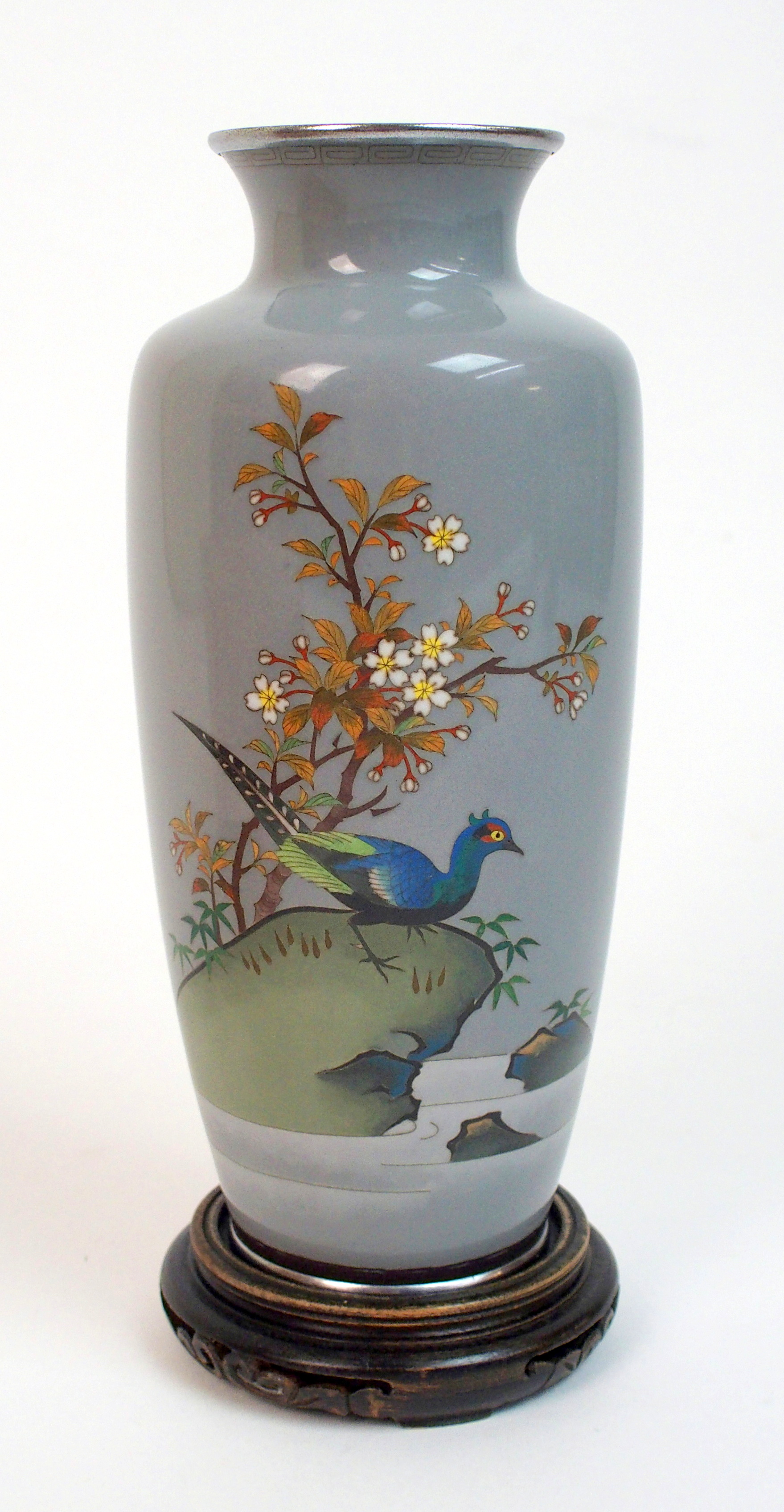 A Japanese cloisonne baluster vase decorated with a pheasant on a rock beneath blossoming branches
