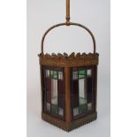 An early 20th century hall lantern of square form with leaded and stained glass panels within a